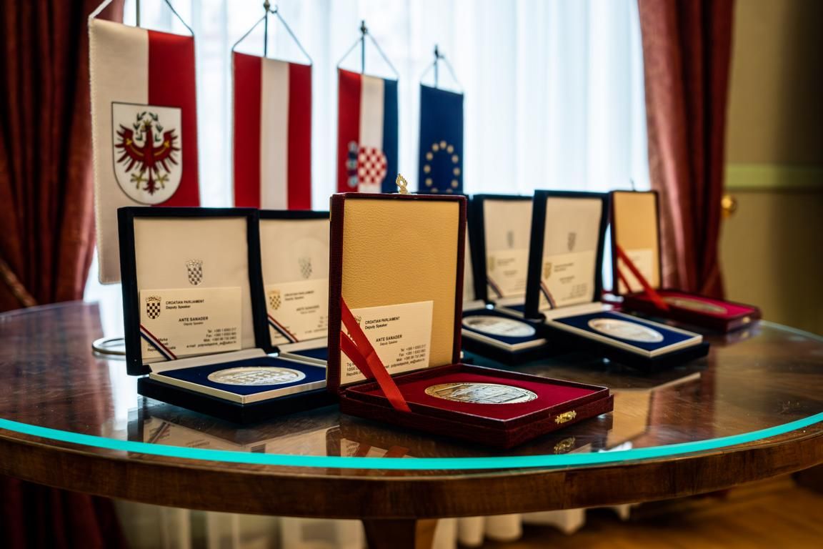Neben LRin Mair erhielten der Projekt-Koordinator Peter Logar sowie in Abwesenheit die vormals f&uuml;r Sicherheitsagenden zust&auml;ndigen Regierungsmitglieder Anton Steixner und Josef Geisler die "Goldene Plakette" verliehen. Die weiteren Projektbeteiligten erhie