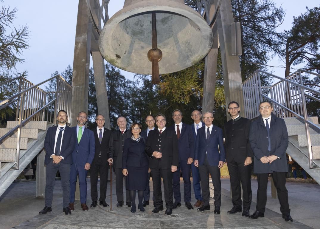 Bei der Friedensglocke des Alpenraumes in M&ouml;sern: v.l. Untersekret&auml;r Gabriele Barucco (Lombardei), Norman Gobbi, Departementvorsteher Christian Rathgeb (Graub&uuml;nden), LH a.D. Alois Partl, Staatsministerin a.D. Emilia M&uuml;ller (Bayern), LH Marc M&auml;chler (St. G